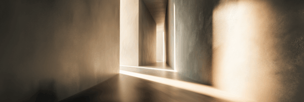 Sunlight casting soft, elongated shadows through a minimalist architectural corridor with textured walls and warm neutral tones, creating a calm, immersive atmosphere.